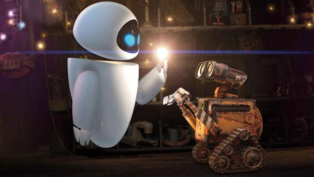 Eve lights a light bulb while WALL-E looks on. 