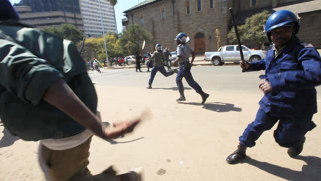 Zimbabwe police officers clash with protestors in Harare.