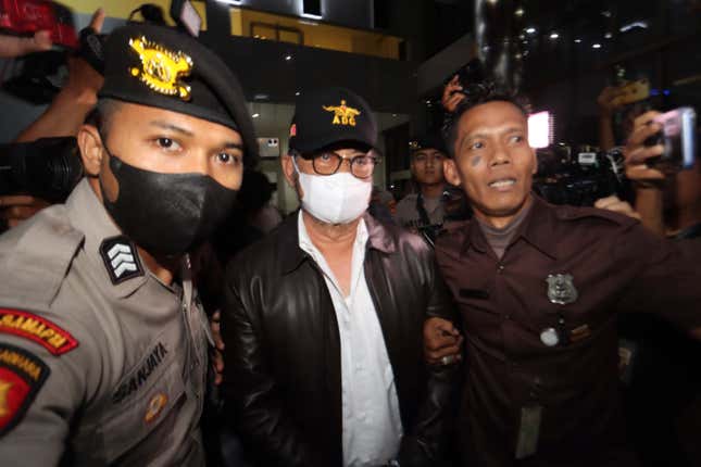 Former Indonesian Agriculture Minister Syahrul Yasin Limpo, center, is escorted by security officers upon arrival at The Corruption Eradication Commission headquarters following his arrest in Jakarta, Indonesia, Thursday, Oct. 12, 2023. Indonesia&#39;s anti-graft commission late Thursday arrested the ex-cabinet minister who was accused of &quot;abuse of power,&quot; bribery and fraudulent projects involving private vendors. (AP Photo/Antasena Kroen)