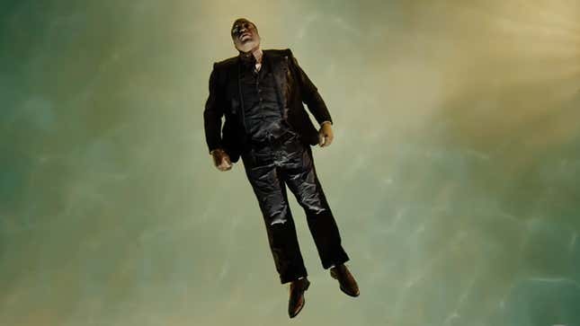 Chiwetel Ejiofor's Farady floats in a pool while still wearing a full suit, in a scene from The Man Who Fell to Earth.