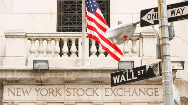 A Wall Street road sign is pictured in front of an entrance to the New York Stock Exchange in the financial district of New York September 19, 2008. Sweeping government measures to rescue the financial system and restore confidence in shaky markets spurred a huge relief rally in U.S. stocks on Friday, ending a week that saw the most dramatic reshaping of the financial landscape since the Great Depression.