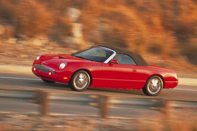 A 2002 Ford Thunderbird drives on a road in this publicity photo. The car was introduced to the media January 7, 2001 at the North American International Auto Show in Detroit, Michigan