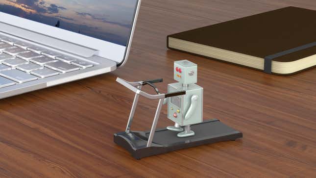 a little robot is walking on a little treadmill on a desk with a laptop and notebook