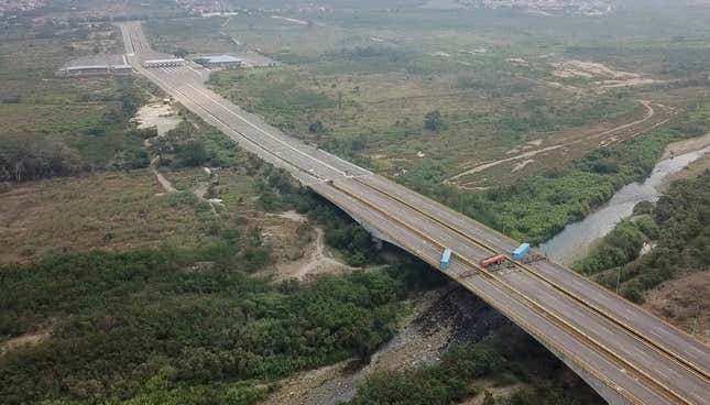 This image taken from video, shows a fuel tanker, cargo trailers and makeshift fencing, blocking the Tienditas International Bridge on Feb. 6.
