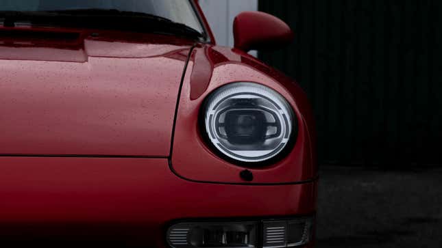 A close-up of a red 993 with the Ruf LED headlights