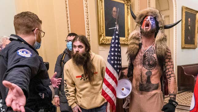 QAnon rioters including Jacob Chansley, better known as the "Q Shaman," confront U.S. Capitol police near the Senate Chamber in the Capitol on Jan. 6.