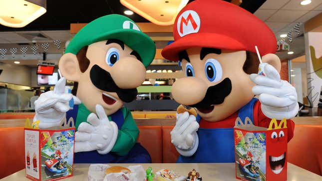 A photo of Mario and Luigi eating Happy Meals in a McDonalds restaurant. 