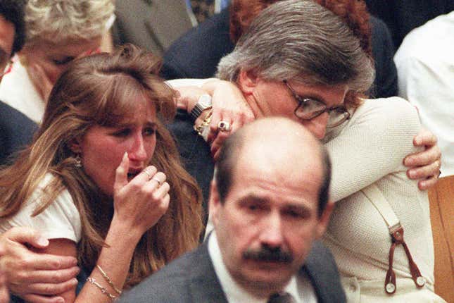 FILE - Fred Goldman, father of Ron Goldman, hugs his wife Patti, as his daughter, Kim, left, reacts during the reading of the not guilty verdicts in O.J. Simpson double-murder trial in Tuesday, Oct. 3,1995, in Los Angeles. Simpson was acquitted in the murders of Goldman and Simpson&#39;s ex-wife Nicole. Foreground is Los Angeles Police Detective Tom Lange, co-lead investigator in the case. Simpson, the decorated football superstar and Hollywood actor who was acquitted of charges he killed his former wife and her friend but later found liable in a separate civil trial, has died. He was 76. (Myung J. Chun/Los Angeles Daily News via AP, Pool, File)