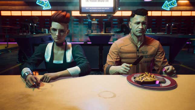 Joshua and a corpo are shown sitting at a restaurant table while he eats.