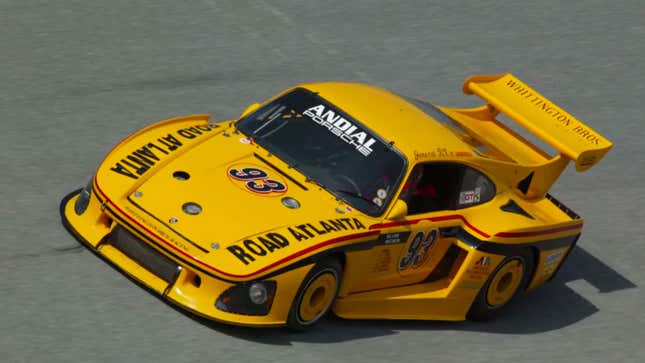 A photo of a yellow Porsche race car. 