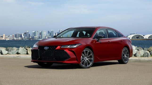 A red Toyota Avalon parked by the seaside