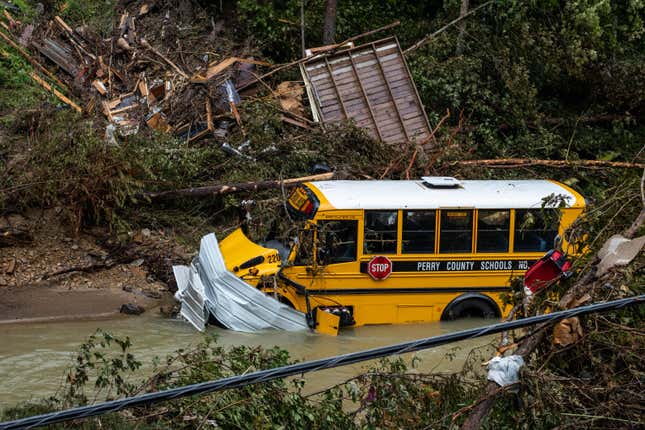 A Perry County school bus, along with other debris, sits in a creek near Jackson, Kentucky, on July 31, 2022.