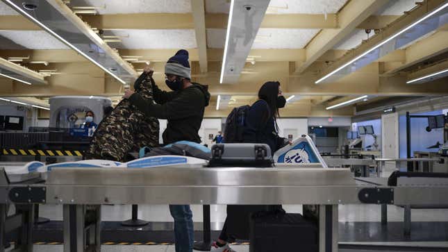 A photo of people at a TSA checkpoint. 