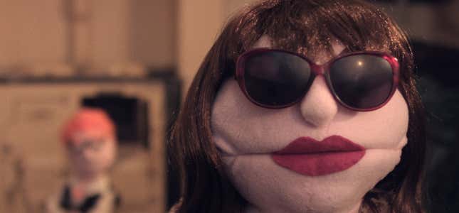 A puppet wearing sunglasses and red lipstick faces the camera in horror-comedy short Snore.