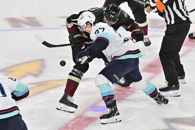 Nov 7, 2023; Tempe, Arizona, USA; Arizona Coyotes center Nick Bjugstad (17) and Seattle Kraken center Yanni Gourde (37) take the opening face off in the first period at Mullett Arena.