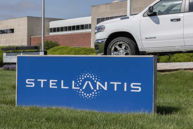 Blue sign with Stellantis logo outside a grassy facility