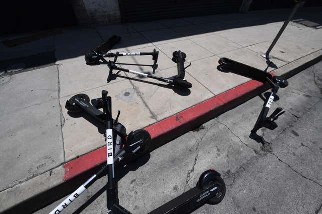 Bird scooters are strewn on a street, June 30, 2020. 