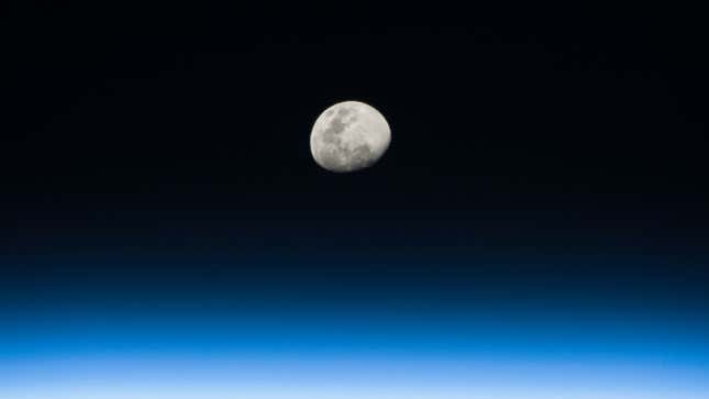 A photo of the moon rising above the Earth 