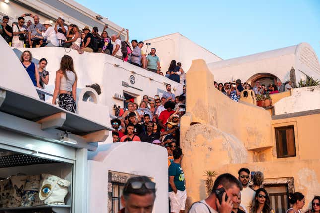 Travellers gathering to watch the sunset at Oia on the island of Santorini, 30 June 2024. With the number of visitors to the island of Santorini increasing unchecked, the authorities are beginning to think about imposing certain limits on the number of travellers. 