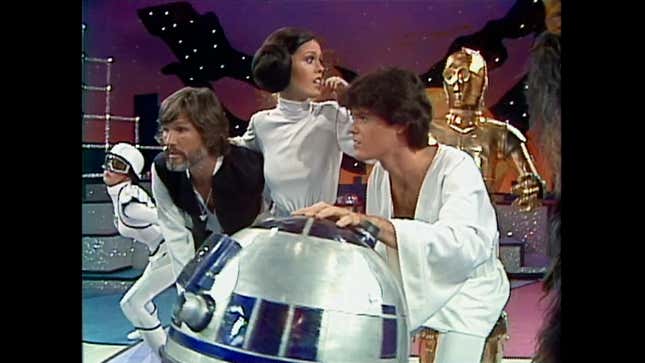 Donny, Marie, Kris Kristofferson, and the droids in a scene from A Disturbance in the Force.