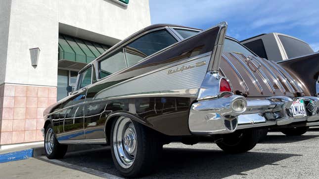 A 1957 Chevrolet Bel Air parked in front of a Krispy Kreme donut shop