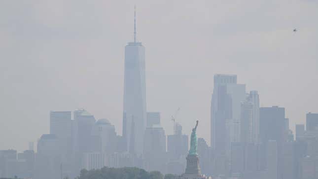 The Statue of Liberty stands in front of a hazy New York City skyline in this view from Jersey City, N.J., on Thursday, June 29, 2023.