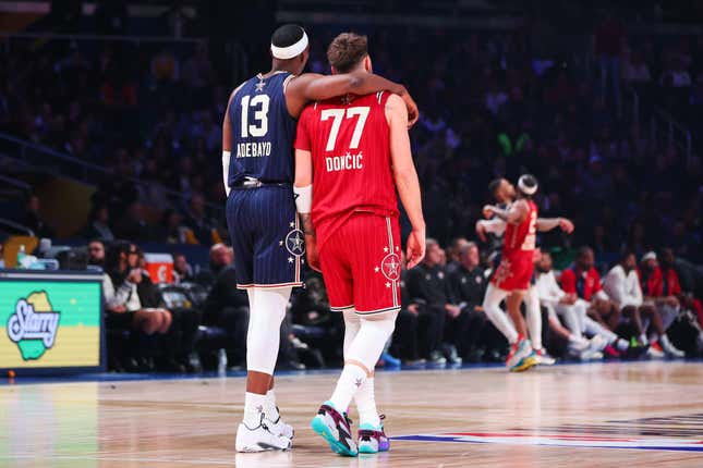INDIANAPOLIS, INDIANA - FEBRUARY 18: Bam Adebayo #13 of the Miami Heat and Eastern Conference All-Stars and Luka Doncic #77 of the Dallas Mavericks and Western Conference All-Stars embrace on the court in the third quarter during the 2024 NBA All-Star Game at Gainbridge Fieldhouse on February 18, 2024 in Indianapolis, Indiana. NOTE TO USER: User expressly acknowledges and agrees that, by downloading and or using this photograph, User is consenting to the terms and conditions of the Getty Images License Agreement. (Photo by Stacy Revere/Getty Images)