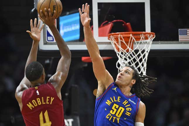 Nov 19, 2023; Cleveland, Ohio, USA; Cleveland Cavaliers forward Evan Mobley (4) shoots beside Denver Nuggets forward Aaron Gordon (50) in the second quarter at Rocket Mortgage FieldHouse.