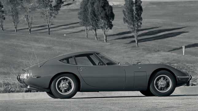 A side-view of a Toyota 2000GT with its fender-mounted wing mirrors