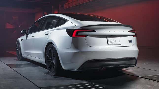 The rear view of a new white Tesla Model 3 Performance