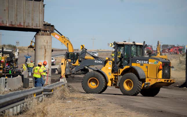 Workers resurface Interstate 25 northbound, Wednesday, Oct. 18, 2023, north of Pueblo, Colo. A train derailed and spilled railcars onto Interstate 25 Sunday, forcing officials to close the main highway and reroute traffic through Pueblo. Colorado Gov. Jared Polis said that the southbound lanes of the interstate will reopen to travellers on Wednesday afternoon; northbound lanes will be navigable some time on Thursday. (AP Photo/David Zalubowski)