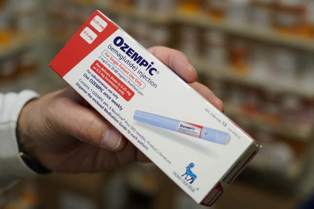 A pharmacist holds a box of Novo Nordisk A/S Ozempic brand semaglutide medication arranged at a pharmacy in Provo, Utah.