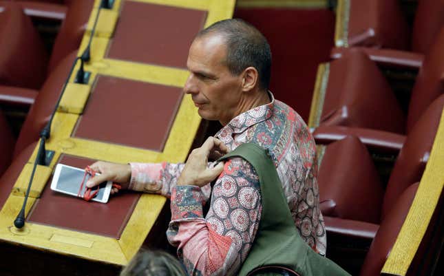 Lawmaker Yanis Varoufakis arrives at a parliament meeting in Athens, on Friday, July 31, 2015. Greek Prime Minister Alexis Tsipras defended his flamboyant former finance minister, Yanis Varoufakis, who came under heavy fire over claims he made and confirmed after they were leaked that he had drafted contingency plans for a parallel payment system that could have eased a euro exit. (AP Photo/Thanassis Stavrakis)