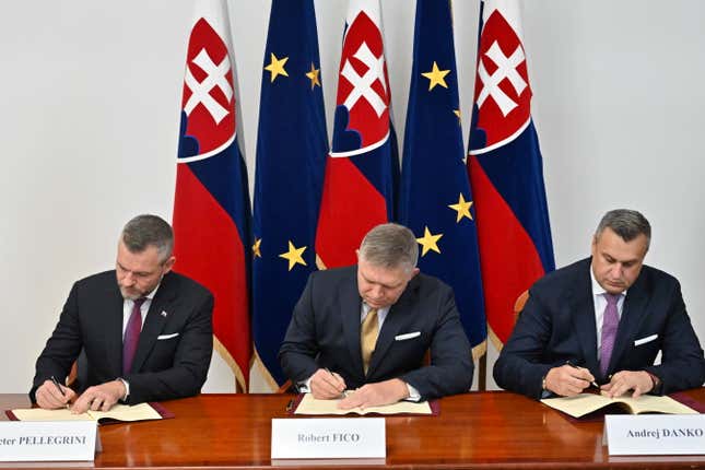 From left, Hlas-Social Democracy party chairman Peter Pellegrini, Smer-Social Democracy party chairman Robert Fico and Slovak National Party chairman Andrej Danko sign a coalition agreement to form a new government in Bratislava, Slovakia, Monday, Oct. 16, 2023. At right is . (Vaclav Salek/CTK via AP)