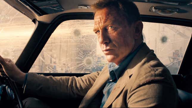 Daniel Craig as James Bond in No Time to Die, sitting in a car with bulletproof glass. 