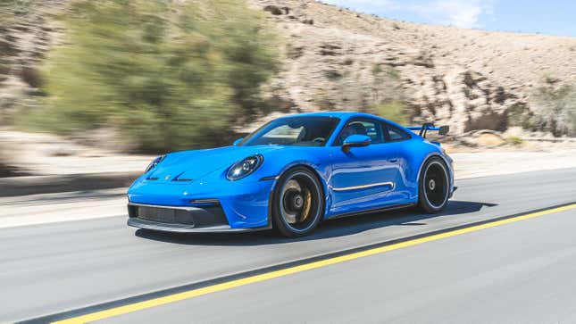 A shark blue Porsche 911 GT3 on a desert highway