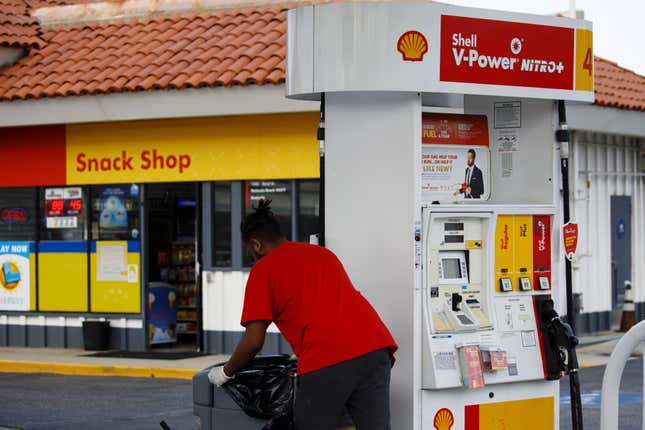 An employee empties trash cans at a Royal Dutch Shell Plc gas station in Redondo Beach, California, U.S., on Sunday, July 28, 2019.