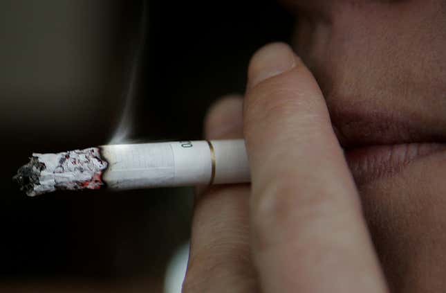 FILE - A smoker in a pub in London, Wednesday Feb. 14, 2006. British Prime Minister Rishi Sunak has proposed raising the legal age that people in England can buy cigarettes by one year, every year until it applies to the whole population. Sunak said the planned change will mean that “a 14-year-old today will never legally be sold a cigarette.&quot; (AP Photo/Kirsty Wigglesworth, File)