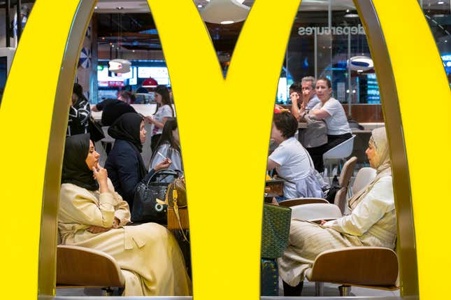 Flight passengers are seen eating a meal at McDonald’s at the Dubai International Airport, United Arab Emirates.