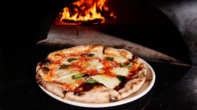 A photo of a pizza in an oven. 