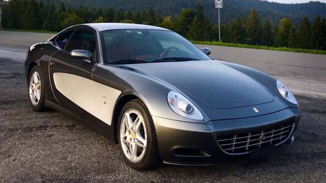 A photo of a grey and white Ferrari 612 sports car. 