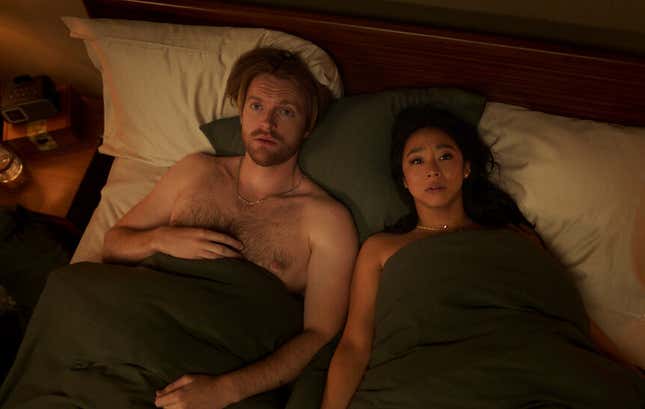 Stephanie Hsu and  Finneas O'Connell laying in bed