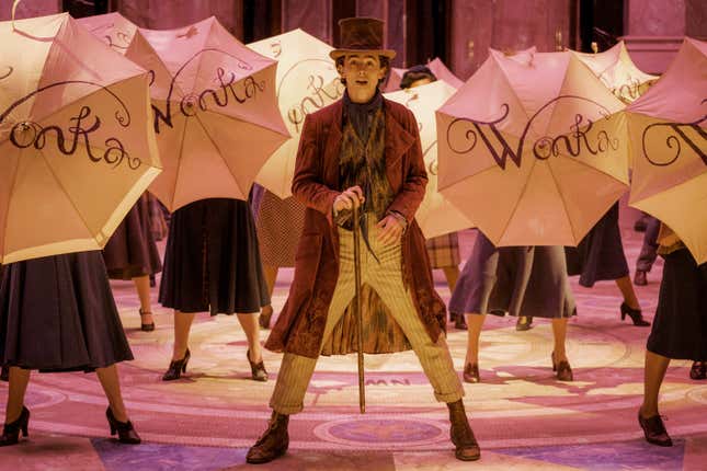 This image released by Warner Bros. Pictures shows Timothee Chalamet, center, in a scene from &quot;Wonka.&quot; (Jaap Buittendijk/Warner Bros. Pictures via AP)