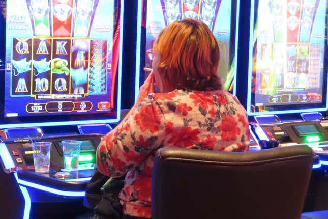 A gambler smokes while playing a slot machine at the Ocean Casino Resort in Atlantic City N.J. on Nov. 29, 2023. On Tuesday, Dec. 12, casino workers pushing for a smoking ban at the city&#39;s nine casinos publicized a letter from Shawn Fain, international president of the United Auto Workers union, calling on New Jersey lawmakers to ban smoking in the casinos. (AP Photo/Wayne Parry)