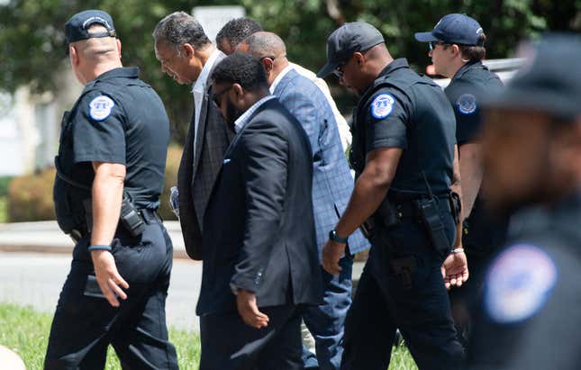 US Capitol Police detain Rev. Jesse Jackson, Sr. (2nd L) as he joins demonstrators in blocking traffic as they call for Senators, specifically US Senator Joe Manchin, Democrat of West Virginia, to support the elimination of the Senate filibuster in order to pass voting rights legislation and economic relief bills, as they protest during the “Moral March,” on Capitol Hill in Washington, DC, June 23, 2021. 