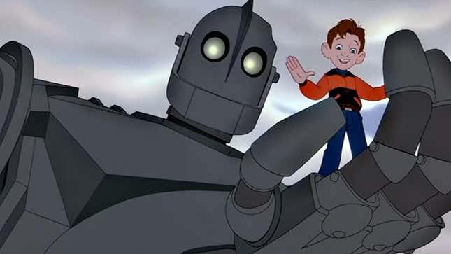 The Iron Giant holds Hogarth in his hand.