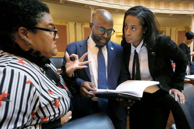 Del. Cia Price, D-Newport News, left, Del. Alex Askew, D-Virginia Beach, center, and Del. Jennifer Carroll Foy, D-Prince William, right, confer during the floor session of the Virginia House of Delegates inside the State Capitol in Richmond, Va., on Feb. 11, 2020.