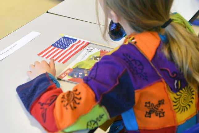 Back of a child with an American flag.