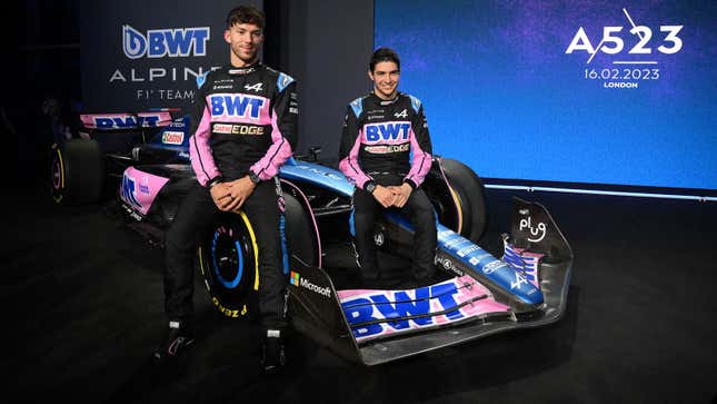 A photo of Pierre Gasly and Esteban Ocon sat on the 2023 Alpine F1 car. 