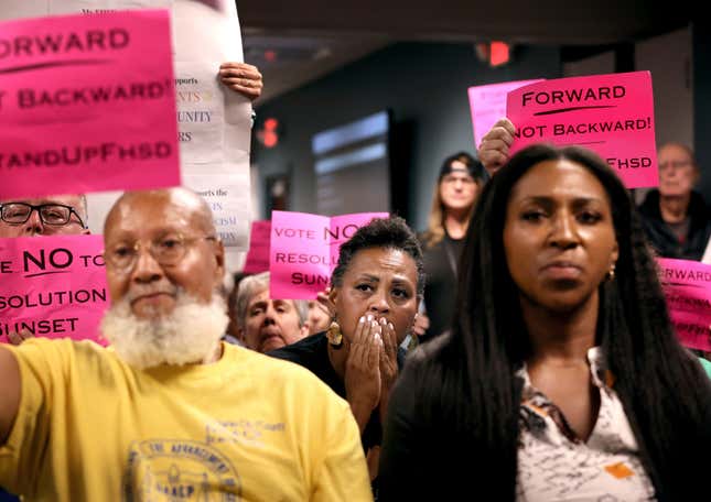 Kimberly Thompson, center, listens as Francis Howell School Board members talk in favor of rescinding all previously passed resolutions, including an anti-racism resolution, during a meeting on Thursday, July 20, 2023 in O’Fallon, Mo.